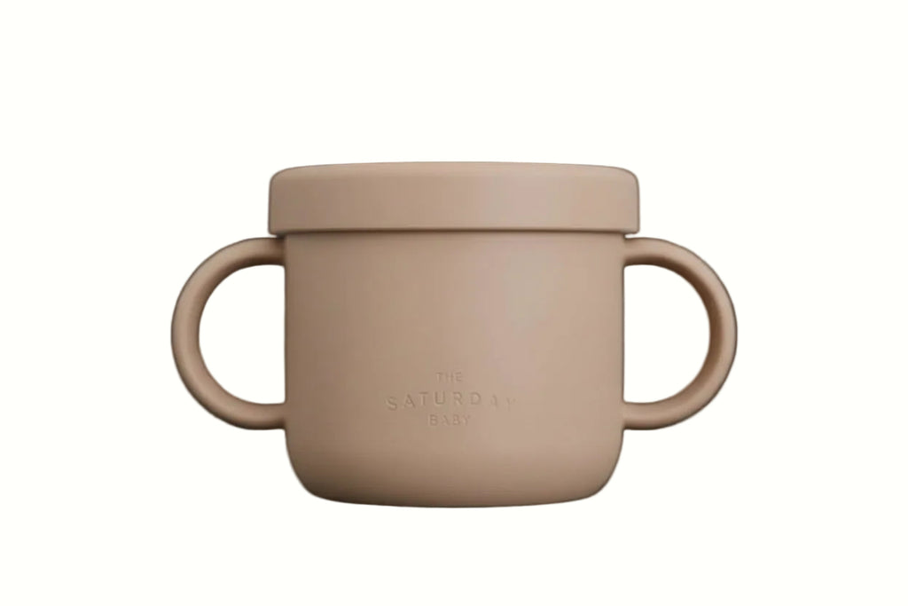 Beige cup with handles and lid on a light gray background